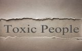 Toxic people written on a piece of old paper.