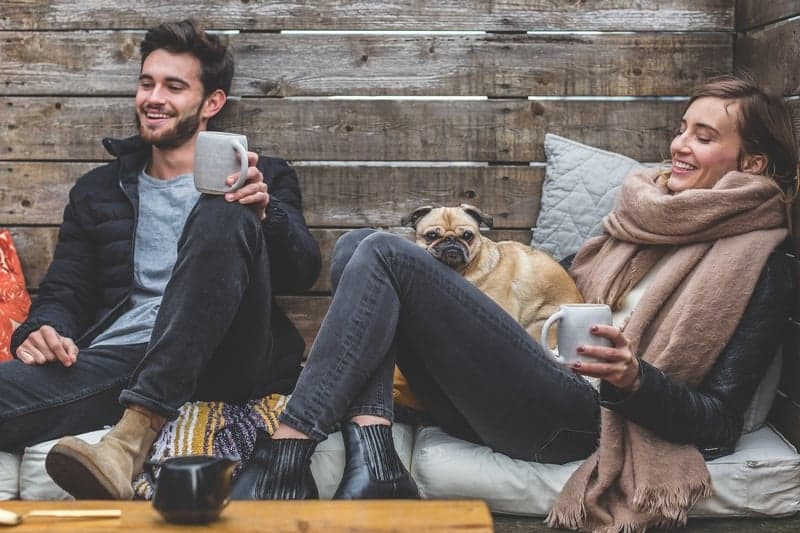 Couple relaxing with their dog
