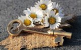 A key engraved with "dream" and some white flowers
